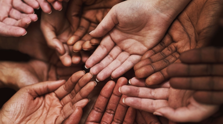 Close up of many hands together, palms up