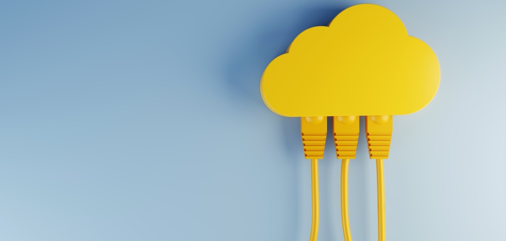 Floating against a soft blue background, three bright yellow power cords descend from a whimsical, cloud-shaped, yellow outlet hub, which they are plugged into.
