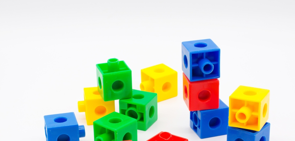 Brightly colored toy blocks are scattered on the floor, as if they were tossed there.