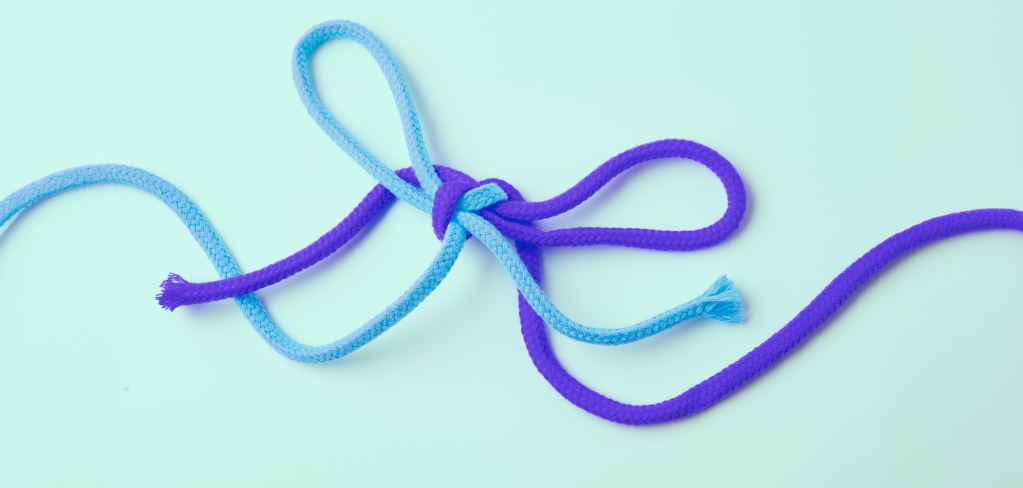 Purple and turquoise strings tied in a knot