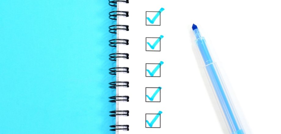 Blue checkboxes in a spiral-bound notebook.