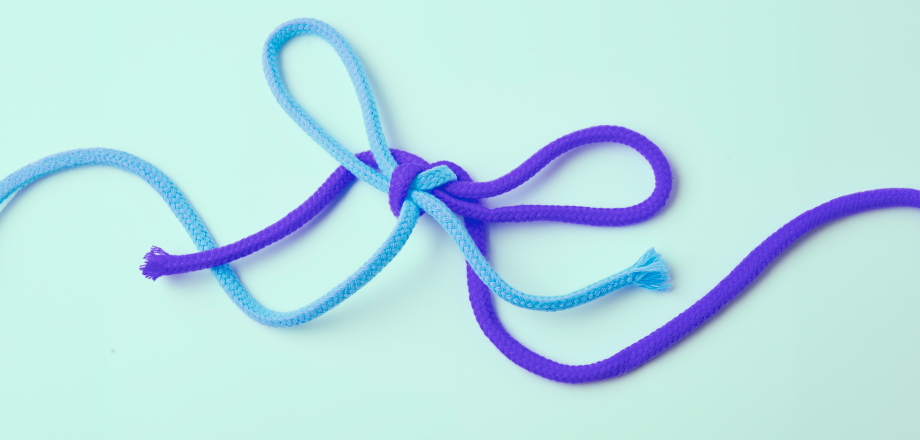 Purple and turquoise strings tied in a knot